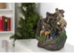 Fontaine zen en polyrésine posée sur un meuble laqué blanc avec statuettes de trois éléphants sur des ramifications d'un arbre avec de l'eau qui s'écoule en son sein
