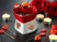 Appareil céramique pour fondue au chocolat posé sur un table avec fourchettes et bougies